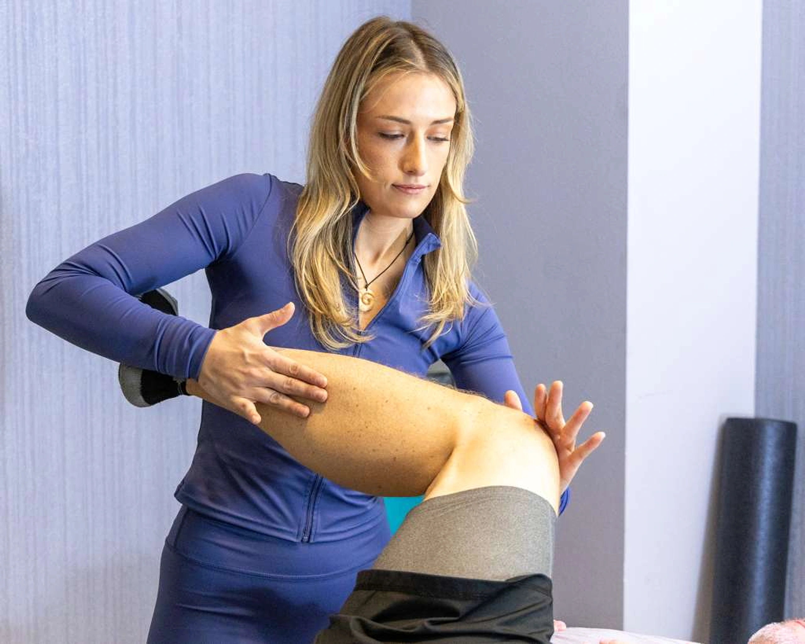 Jo guiding a client through an assisted stretching session in Tampa